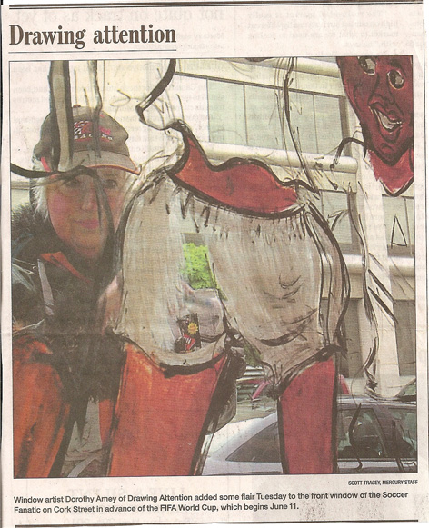 Article in Guelph Mercury featuring Dorothy Amey painting window art on a local business.